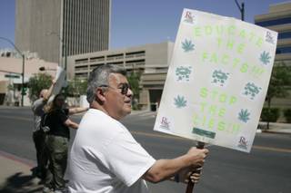 Roque Perea, a medical marijuana patient, joins about a dozen others for the Million Marijuana March on Saturday in front of the Regional Justice Center.