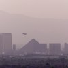 An airplane takes off from McCarran International Airport as hotel-casinos on the Strip are partially shrouded in haze in this Sun file photo from 2001.  