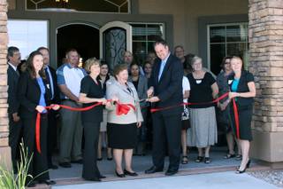Jonathan Fore, right, the vice president of developer Fore Property, cuts a ribbon during the grand opening of the Arbor Pointe apartment complex with Bureau of Land Management District Manager Mary Jo Rugwell and County Commissioner Susan Brager, left.