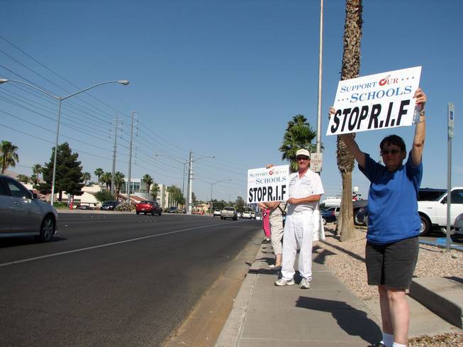 Sue Schucker, a library aide, left, and Randy T. Morris, a painter for the Clark County School District, picket in front of the Edward Greer Education Center, 2832 E. Flamingo Road, as the Clark County School Board meets on Thursday. They are members of the Education Support Employees Association, the union that represents school support staff.