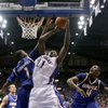 Kansas' Quintrell Thomas (11) gets past UMKC's James Humphrey (1) and Latreze Mushatt (4) to put up a shot during the first half on Nov. 16, 2008, in Lawrence, Kan. Thomas announced on April 9 that he will transfer from KU.