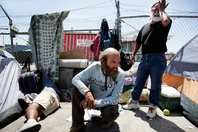 Leo Afshar, from right, Bill Levenson and Johnny Van hang out in the homeless encampment on Foremaster Lane between Las Vegas Boulevard North and Main Street in Las Vegas on Friday, May 15, 2009. 