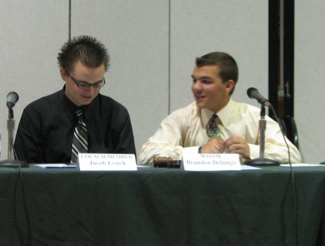 Boulder City High School seniors Jacob Lynch, left, and Branden DeLangis, take the seats of city councilman and mayor, respectively, May 21 during the annual Youth City Council meeting at the Boulder City Recreation Center, which is serving as the Council Chambers while early voting continues in City Hall.