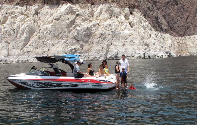 Visitors jump into Lake Mead from the back of a boat Friday.