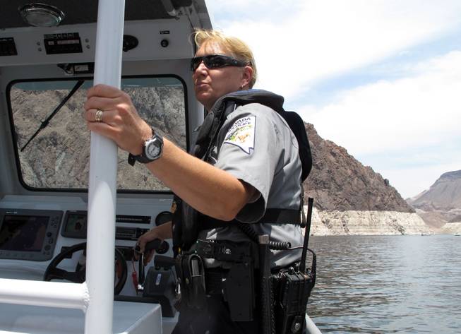 Nevada Department of Wildlife Warden Karen Welden watches boaters on Lake Mead Friday.