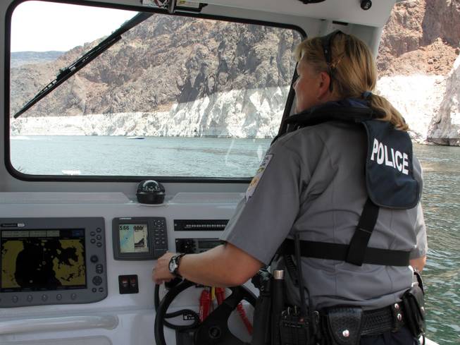 Nevada Department of Wildlife Warden Karen Welden patrols Lake Mead Friday.