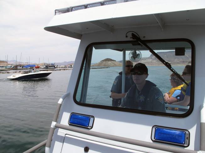 Nevada Departmnet of Wildlife Warden Randy Bond drives a patrol boat into Lake Mead Marina on Friday.