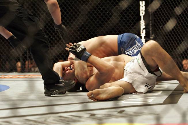 Mike Pyle, bottom, taps out in his welterweight against Brock Larson at UFC 98 at MGM Grand Garden Arena in Las Vegas on Saturday, May 23, 2009.