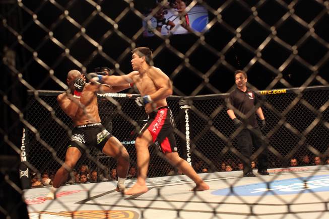 Rashad Evans, left, gets knocked out at the end of the second round in his bout with Lyoto Machida in UFC 98 at the MGM Grand Garden Arena in Las Vegas on Saturday, May 23, 2009.