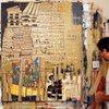 Artist Biscuit Street Preacher of Boulder City looks at his painting 
