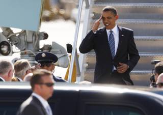 President Barack Obama salutes as he arrives at McCarran International Airport Tuesday.