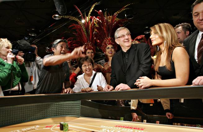 Jimmy Kumihiro of Hawaii throws the final craps game with Bill Boyd on hand, center, during the closing of the Stardust Resort and Casino on Wednesday morning.