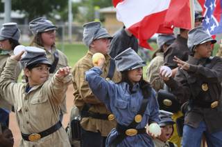 Confederate soldiers Liliana Amezcua, left, and Lizbeth Santiago-Cruz take aim at Union troops while fighting in the Battle of Bull Run during the fifth-grade annual Civil War Reenactment Friday at Edna Hinman Elementary School.