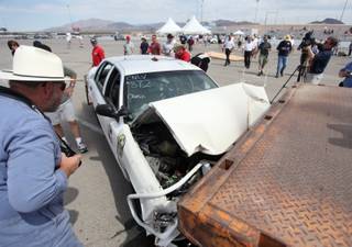 A controlled high-impact collision of a car into a tractor-trailer is shown Monday during the annual Crash Conference hosted by the North Las Vegas Police Department Traffic Division at the Las Vegas Motor Speedway.