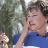 Gloria Hernandez dabs her eye while listening to speakers during a press conference launching the na