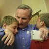 Cam Walker receives a hug from his twin sons, Nicholas and Marcus, right, after winning the seat on the Boulder City Council in the general election Tuesday. Walker had a watch party at Kirk and Vivian Harrison's home.