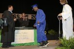 LaQuan Phillips walks across the stage on his own to receive his diploma from Southeast Region Assistant Superintendent Pat Skorkowsky, left, during the Green Valley High 2009 graduation ceremony Tuesday at the Thomas & Mack Center.