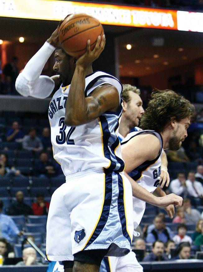 Memphis Grizzlies O.J. Mayo, left, grabs a rebound against the New Orleans Hornets  in the first quarter of an NBA basketball game Feb. 9 in Memphis. 