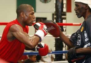 Boxer Floyd Mayweather Jr., left, works on his timing with his uncle Roger Mayweather during a workout in his gym Thursday, June 11, 2009.  