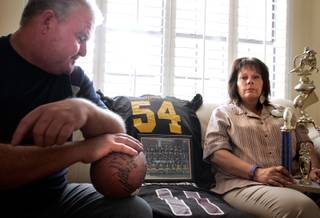 Bob Luscombe and Marie Passante are the parents of former Clark High School football player Chris Luscombe, who was killed as the result of a drive-by shooting in June 2008. They both hold various memorabilia from their son's life and football career. 