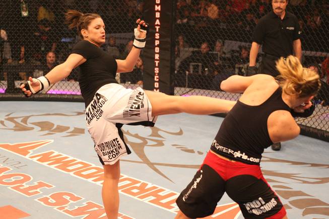 In this photo released by The Rose Group Gina Carano, left, kicks Julie Kedzie during the Elite Xtreme Combat mixed martial arts competition, Saturday, Feb. 10, 2007, at the DeSoto Civic Center in Southaven, Miss. Carano takes on Cristiane "Cyborg" Santos on Aug. 15 for the first-ever Strikeforce women's 145-pound title.