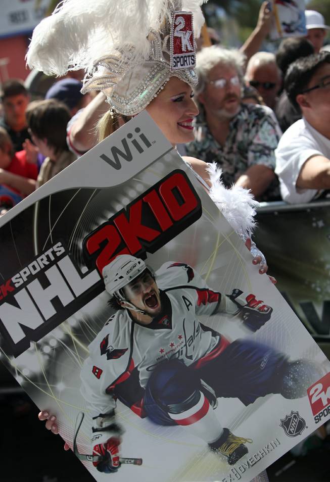 A 2K Sports show girl on the red carpet holds a poster of the new NHL 2K10 video game outside the Palms Thursday prior to the NHL Awards show.
