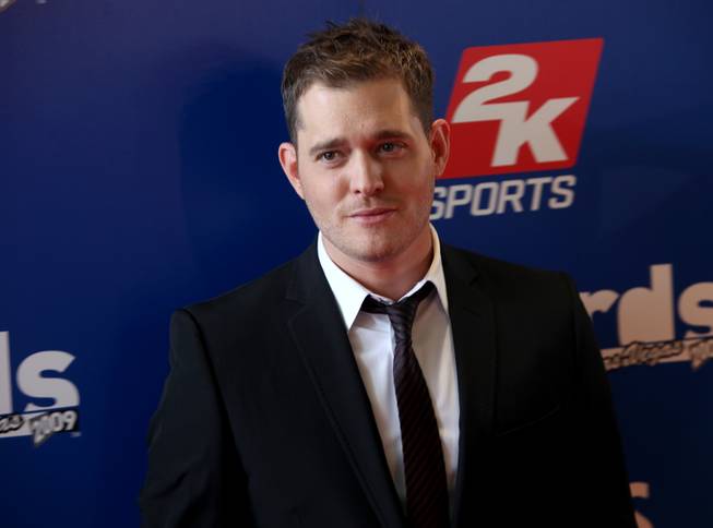 Singer Michael Buble stops for photographs on the red carpet outside the Palms Thursday prior to the NHL Awards show.