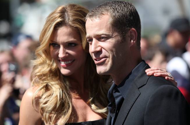 Actors Colin Ferguson, and Tricia Helfer stop for photographs on the red carpet outside the Palms Thursday prior to the NHL Awards show.