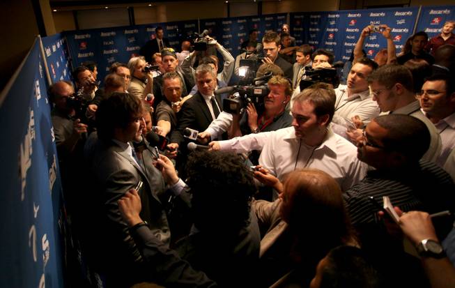 A throng of media members interview Washington Capitals forward Alexander Ovechkin inside the Palms Thursday. Ovechkin won the Hart Memorial Trophy, Lester B. Pearson Award and the Maurice Richard Trophy.