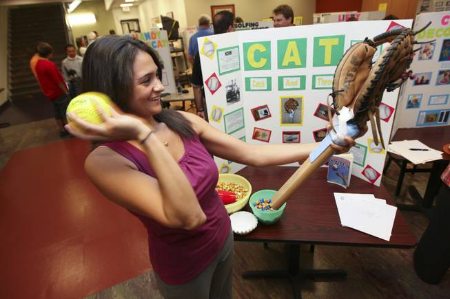 Renee DiPucciu throws a ball while demonstrating her catch and throw prosthetic hand invention Thursday during the annual student Assistive Technology Fair at Touro University.