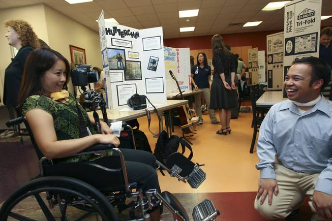 Assistant Professor Dr. Cynthia Lau takes a picture of student Jummel Hidrosollo while trying out his Wheelchair ShutterChin invention Thursday during the annual student Assistive Technology Fair at Touro University.