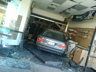 Nevada Supreme Court Justice Kris Pickering's Mercedes sits inside a UPS Store after a stuck accelerator caused the car to drive through the front windows of the store.