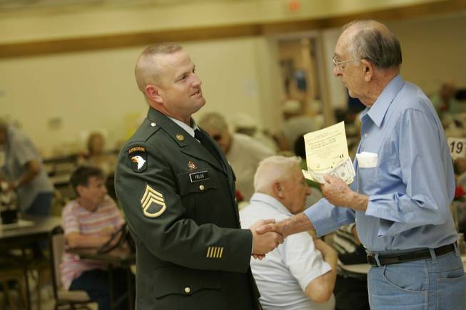 Army Staff Sgt. Jonathan Fields, left, talks with Frank Mathews at the Boulder City Senior Center on June 19.