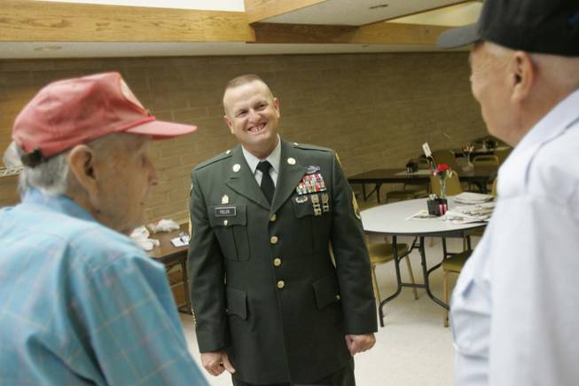 Army Staff Sgt. Jonathan Fields, center, chats with Danny Noonan, left, and Arthur Monetti at the Boulder City Senior Center on  June 19.