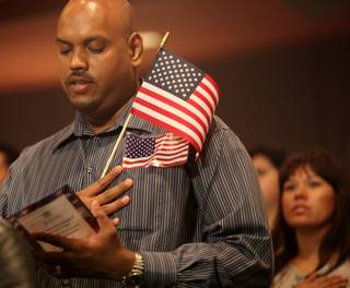 Venkatesh Sunder Tittle, originally from India, recites the Pledge of Allegiance during a Thursday swearing-in ceremony at Las Vegas City Hall. Tittle was one of more than 100 Las Vegas-area residents who participated in the ceremony for new citizens conducted by U.S. Citizen and Immigration Services and the city of Las Vegas.