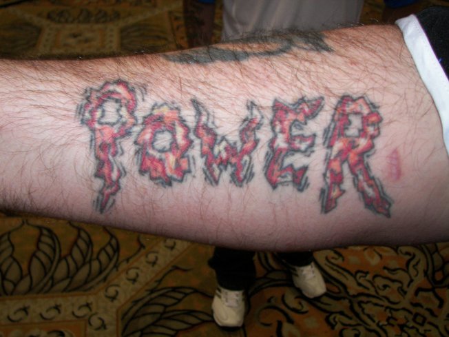 The right forearm of Phil "The Power" Taylor, which is a conveniently showcased when the 14-time world champion throws darts.