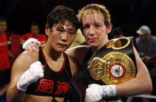 Fujin Raika, left, of Tokyo and WBA/GBU lightweight champion Layla McCarter of Las Vegas pose after a 10-round fight at the South Point Friday, July 3, 2009. McCarter defended her titles with a unanimous decision win.