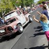 Children wave to an old pickup truck designed after the Pixar character "Mater" from the animated movie "Cars," during the 15th annual Summerlin Council Patriotic Parade on Saturday.