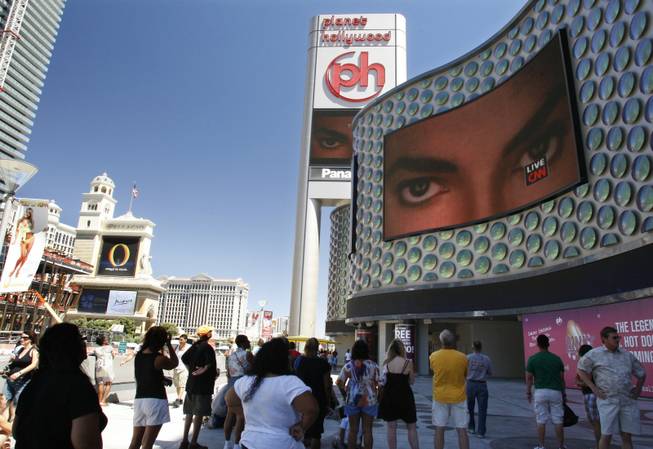 People watch live television news coverage of the Michael Jackson memorial outside Planet Hollywood on Tuesday.