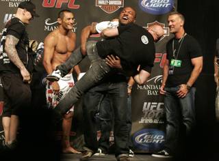 Quinton Jackson threatens to throw UFC President Dana White to the ground at the weigh-in for UFC 100.