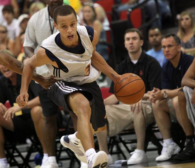 Golden State guard Stephen Curry drives against Houston during the Warriors' 73-69 loss to the Rockets in opening day action of the NBA summer league at COX Pavilion. Curry was grabbed at and knocked around by Houston repeatedly as his foes attempted to get in his head.