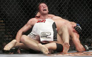 Mark Coleman gets Stephan Bonnar up against the fence during their fight at UFC 100. Coleman won by unanimous decision.