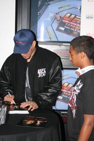 Frank Mir poses for pictures and signs autographs for fans at ESPN Zone at New York New York following UFC 100.