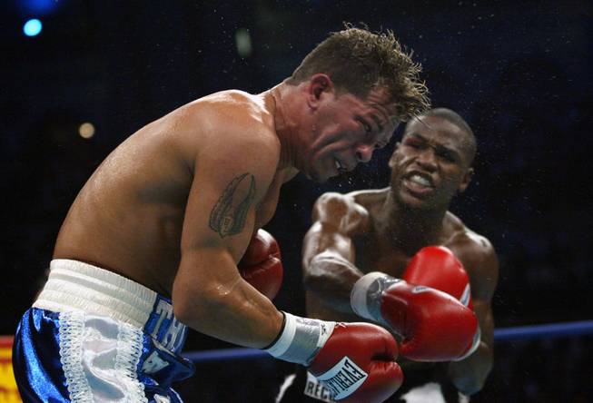 Floyd Mayweather Jr., right, of Las Vegas, Nev., hits Arturo Gatti of Jersey City, N. J. in second round action of their WBO World Super Lightweight Championship bout at Atlantic City's Boardwalk Hall Saturday, June 25, 2005 in Atlantic City, N.J.
