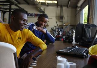 Super bantamweight boxer Guillermo Rignondeaux, a two-time Olympic gold medalist, left, and 2004 Olympic silver medalist Yudel Johnson, both of Cuba, look at photos on a laptop computer before a workout Thursday, July 9, 2009. The Cubans will be featured in a July 17 fight card at Planet Hollywood. 
