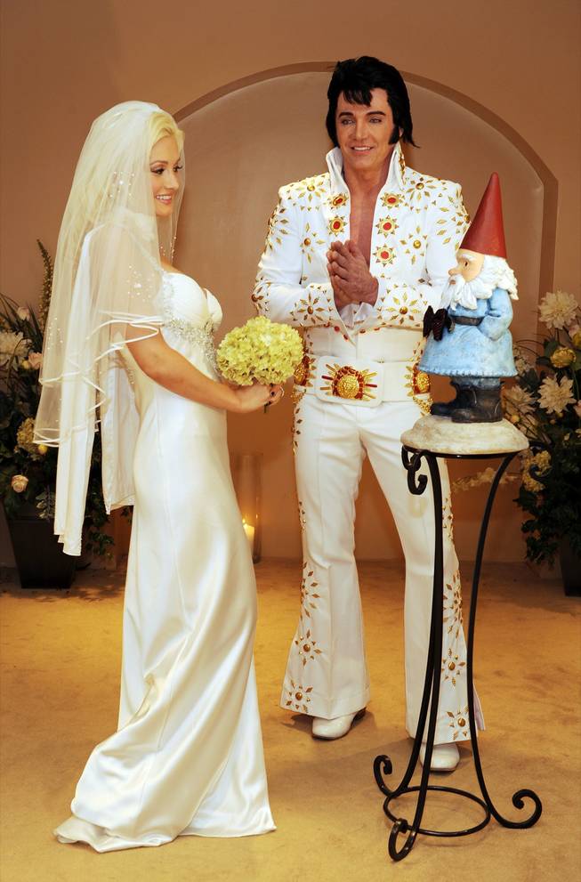 Holly Madison ties the knot with the Travelocity gnome as Elvis impersonator Tim Welch officiates at The Wedding Chapel at Planet Hollywood Resort & Casino on July 12, 2009, in Las Vegas. 