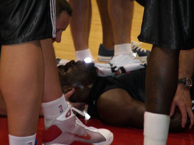 Toronto Raptors forward Ekene Ibekwe is looked after by medical personnel after falling hard on his face Wednesday night in an NBA Summer League game at Cox Pavilion.