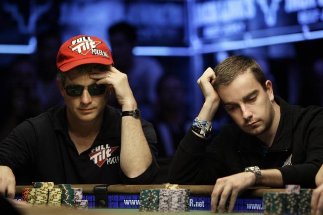 Steven Begleiter, left, and Antoine Saout play a hand during the World Series of Poker at the Rio Hotel and Casino in Las Vegas on Wednesday, July 15, 2009.
