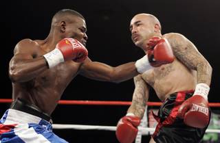Guillermo Risondeaux punches Roberto Guillen enters the ring during Friday Night Fights at Planet Hollywood.