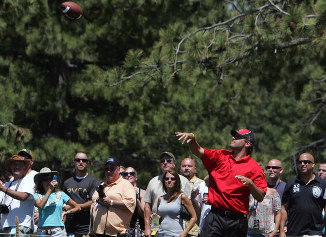 Pittsburgh Steelers quarterback Ben Roethlisberger throws a football to a fan on the 17th hole during the American Century Golf Championship at Edgewood Tahoe Golf Course in Stateline, Nev., on Saturday, July 18, 2009.